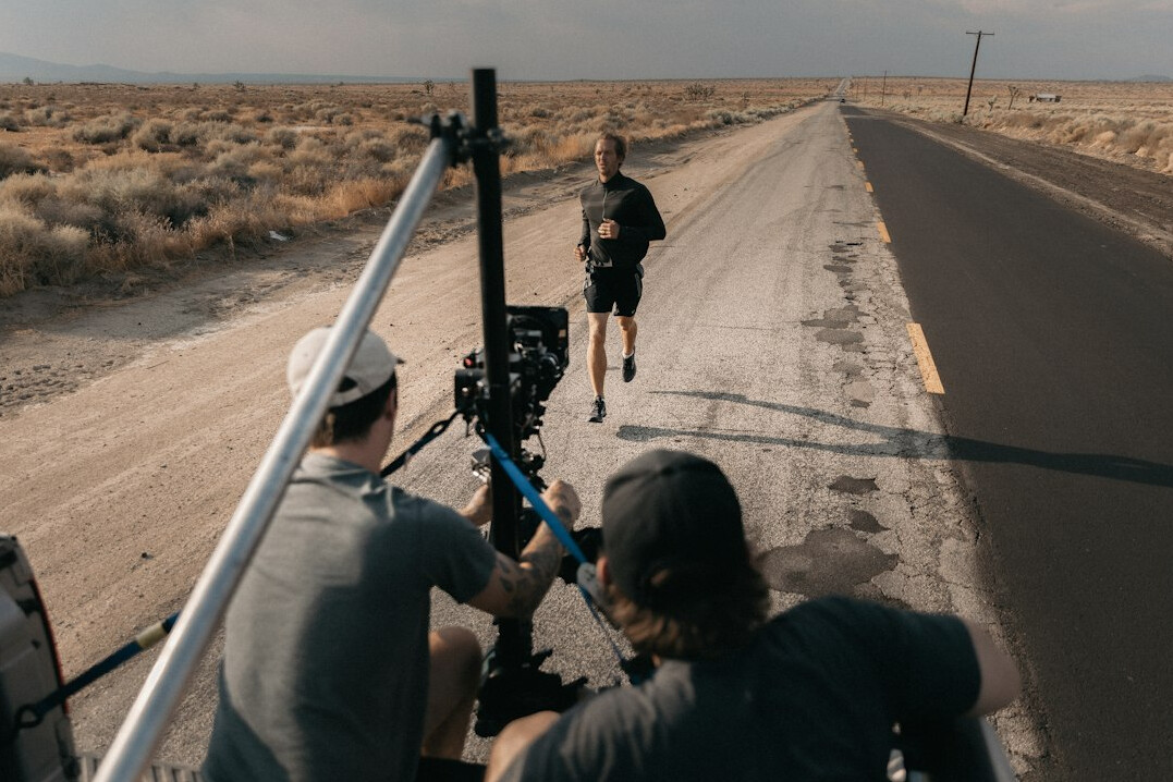 cinematographer adjusting lens